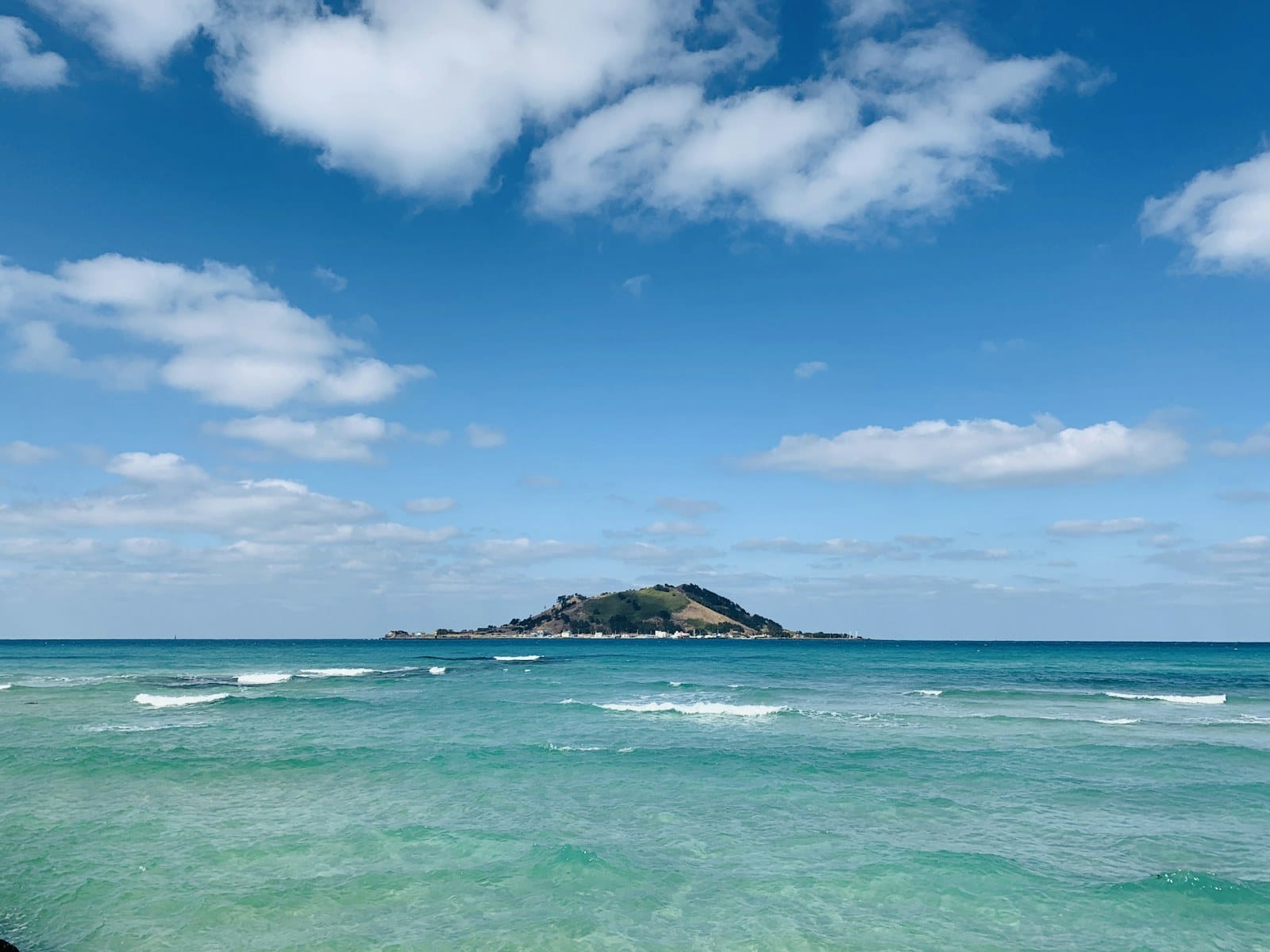 Turquoise sea and a green island off the Jeju coast