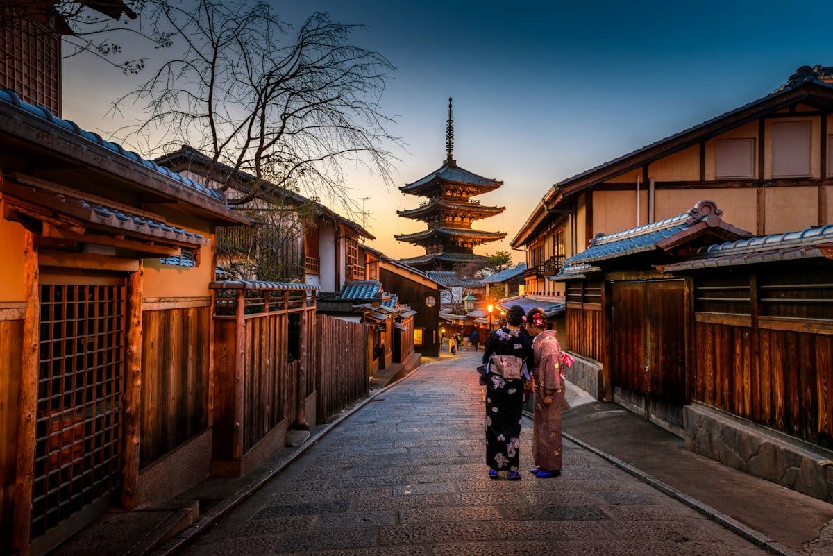 Traveler planning Japan trip with maps and guidebooks showing practical preparation