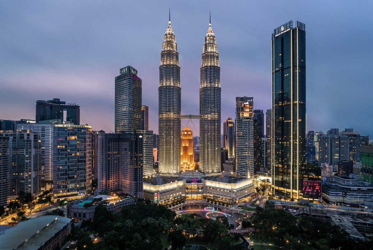 Kuala Lumpur city skyline with iconic Petronas Twin Towers at sunset