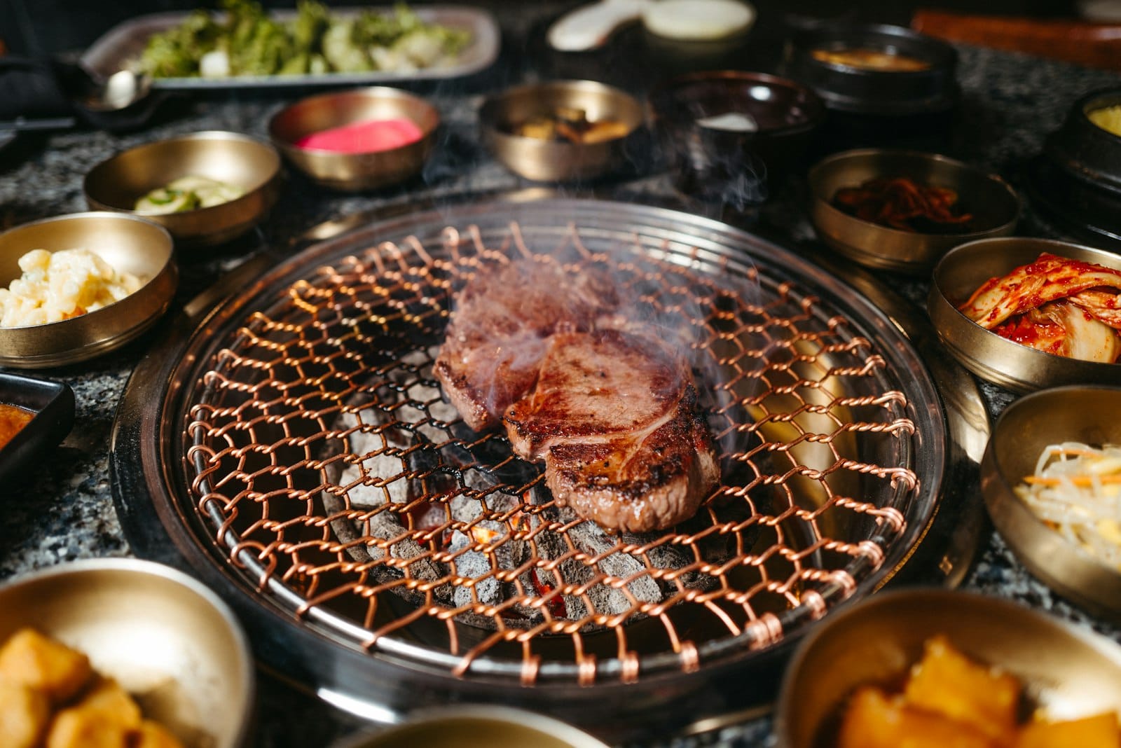 Korean BBQ table with various banchan side dishes